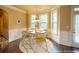 Staged dining area with wainscoting, chandelier, and dining room table at 85 Providence Pkwy, Covington, GA 30014