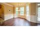 Dining area with natural light, hardwood floors, wainscoting, and access to the kitchen at 85 Providence Pkwy, Covington, GA 30014