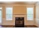 Cozy fireplace with white mantle flanked by two windows providing natural light at 85 Providence Pkwy, Covington, GA 30014