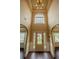 Grand foyer with high ceilings, a decorative front door, and beautiful hardwood floors and trim at 85 Providence Pkwy, Covington, GA 30014