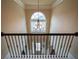 Elegant foyer featuring a decorative chandelier and wrought iron railing at 85 Providence Pkwy, Covington, GA 30014