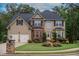 Charming two-story home boasts a manicured front lawn and well-maintained landscaping with a two car garage at 85 Providence Pkwy, Covington, GA 30014