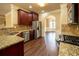 Kitchen area featuring stainless steel appliances, granite countertops, and access to the dining area at 85 Providence Pkwy, Covington, GA 30014