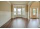 Bright living room with dark hardwood floors, a bay window, and elegant trim work at 85 Providence Pkwy, Covington, GA 30014