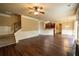 Open-concept living room with hardwood floors and staircase leading upstairs and adjacent kitchen at 85 Providence Pkwy, Covington, GA 30014