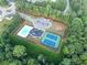 Aerial view showcasing community amenities, including a pool, playground, and tennis courts at 1236 Maston Rd, Auburn, GA 30011