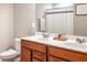 Bathroom with double vanity, wood cabinets, and large mirror, offering a functional and stylish space at 1236 Maston Rd, Auburn, GA 30011