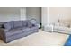 A gray couch in the living room with carpet at 1236 Maston Rd, Auburn, GA 30011