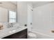 Bright bathroom featuring a shower-tub combo and a dark vanity offering a modern look at 145 Laurel Crest Aly, Johns Creek, GA 30024