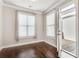 Bedroom featuring neutral walls, wood floors, and a door leading to a private deck at 145 Laurel Crest Aly, Johns Creek, GA 30024