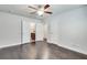 Bright bedroom featuring hardwood floors, a ceiling fan and an ensuite bathroom, providing an ideal private retreat at 145 Laurel Crest Aly, Johns Creek, GA 30024