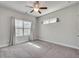 Bright bedroom featuring neutral walls, carpet, and a ceiling fan, creating a cozy and inviting atmosphere at 145 Laurel Crest Aly, Johns Creek, GA 30024