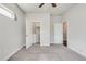 Neutral bedroom showcasing carpet flooring, a ceiling fan, an attached closet, and an ensuite bath at 145 Laurel Crest Aly, Johns Creek, GA 30024