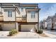 Modern townhome featuring a private balcony, attached garage, and neutral siding at 145 Laurel Crest Aly, Johns Creek, GA 30024