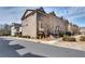 Street view of townhomes with beautiful brick facades and landscaping at 145 Laurel Crest Aly, Johns Creek, GA 30024