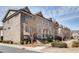 Street view of brick townhomes featuring well-maintained landscaping and walkways at 145 Laurel Crest Aly, Johns Creek, GA 30024