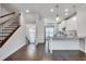 Open concept kitchen with white cabinets, stainless appliances and hardwood floors at 145 Laurel Crest Aly, Johns Creek, GA 30024