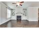 Living room with ceiling fan, fireplace, built in shelving and hardwood floors at 145 Laurel Crest Aly, Johns Creek, GA 30024