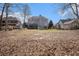 Large grassy backyard view of the home, mature trees, a shed, and swing set at 358 Woodbrook Crst, Canton, GA 30114