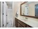 Bathroom with single sink vanity and framed mirror, plus tub with shower at 358 Woodbrook Crst, Canton, GA 30114