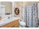 Bathroom with single sink vanity and a shower/tub combo at 358 Woodbrook Crst, Canton, GA 30114