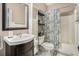 Full bathroom featuring dark wood vanity, decorative shower curtain and linen shelving for ample storage at 358 Woodbrook Crst, Canton, GA 30114