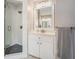 Bathroom features a large glass enclosed shower, large framed mirror, white cabinets and a speckled gray towel at 358 Woodbrook Crst, Canton, GA 30114