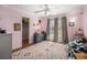 Bright bedroom boasts a patterned rug, ceiling fan and neutral window treatments at 358 Woodbrook Crst, Canton, GA 30114