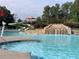 Community pool with a waterfall feature and waterslide at 358 Woodbrook Crst, Canton, GA 30114