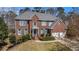 Beautiful two-story brick home with a manicured lawn, gray shutters, and a two-car garage at 358 Woodbrook Crst, Canton, GA 30114