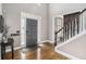 Inviting foyer with hardwood floors, a gray front door, staircase, and elegant decor at 358 Woodbrook Crst, Canton, GA 30114