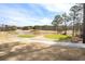 Scenic view of the golf course with a pond and lush green fairways at 358 Woodbrook Crst, Canton, GA 30114