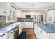 Well-lit kitchen with white cabinets, stainless steel appliances, and dark countertops at 358 Woodbrook Crst, Canton, GA 30114