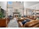 Bright living room with high ceilings, a fireplace, and a comfortable leather sectional sofa at 358 Woodbrook Crst, Canton, GA 30114