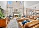 Bright living room featuring a cozy fireplace, plush leather seating, and a stylish area rug at 358 Woodbrook Crst, Canton, GA 30114