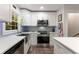 Kitchen featuring white cabinets, stainless steel appliances, ample counter space, and a large window at 2653 Hatfield Se Cir, Atlanta, GA 30316