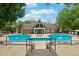 Community pool area with chairs, landscaping, and a luxurious pool house at 605 Mcgill Park Ne Ave, Atlanta, GA 30312