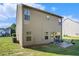 Wide shot of backyard with a patio and seating area on the lawn, perfect for relaxing or entertaining at 71 Pulaski Ave, Hampton, GA 30228