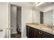 Bathroom featuring double sink vanity with granite countertop, tile flooring, and separate room for toilet at 71 Pulaski Ave, Hampton, GA 30228