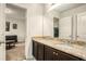 Bathroom featuring a double vanity with granite countertops and dark wood cabinets, bright and functional at 71 Pulaski Ave, Hampton, GA 30228