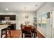 Dining area featuring a wood table, granite countertop, and access to a bright window at 71 Pulaski Ave, Hampton, GA 30228