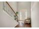 Bright foyer with hardwood floors, staircase, and an inviting chair bathed in light from the front door's sidelights at 71 Pulaski Ave, Hampton, GA 30228