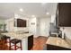 Modern kitchen features granite countertops, wooden cabinets, stainless steel appliances, and a convenient breakfast bar at 71 Pulaski Ave, Hampton, GA 30228