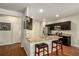 Open-concept kitchen features granite counters, a central island with bar seating, and stainless steel appliances at 71 Pulaski Ave, Hampton, GA 30228