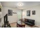 Cozy living room featuring modern decor, including a sleek futon and artwork, perfect for relaxation at 71 Pulaski Ave, Hampton, GA 30228