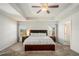 Spacious main bedroom features a large bed, neutral carpet, tray ceiling, and abundant natural light at 71 Pulaski Ave, Hampton, GA 30228