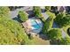 Aerial view of the community pool with lounge chairs surrounded by mature trees at 11 York Trce, Cartersville, GA 30121