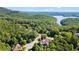 A serene aerial view capturing a home nestled amidst lush greenery, offering a glimpse of the nearby lake at 11 York Trce, Cartersville, GA 30121