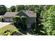 Back of house featuring a two-car garage and well-manicured lawn and landscaping at 11 York Trce, Cartersville, GA 30121