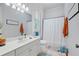 Well-lit bathroom with white vanity, shower with curtain, and tiled floors at 11 York Trce, Cartersville, GA 30121